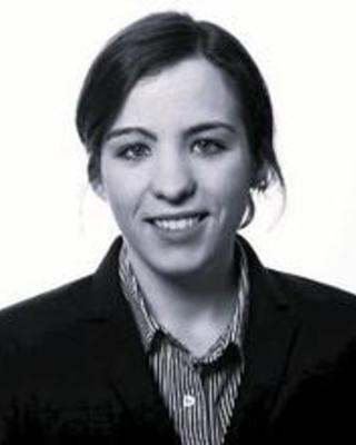 headshot of dark haired woman